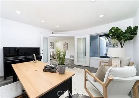 a living room with furniture and a potted plant