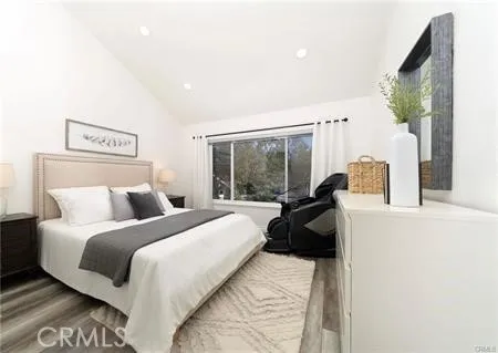 a bedroom with a bed and a large window