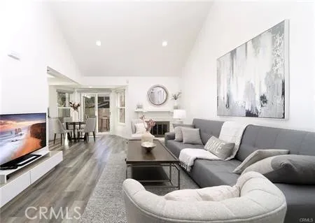a living room with furniture flat screen tv and a fireplace