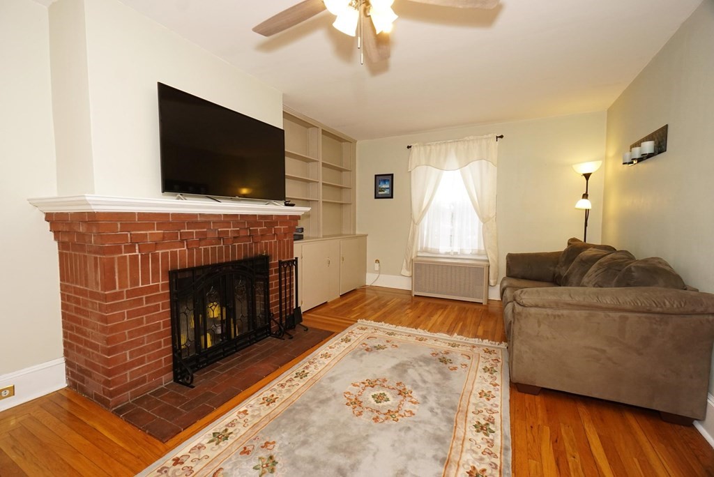 14 East Prospect Street Methuen, MA 01844 - Photo 29 of 42 a living room with a fireplace and a flat screen tv