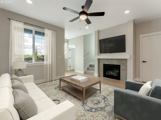a living room with furniture and a fireplace