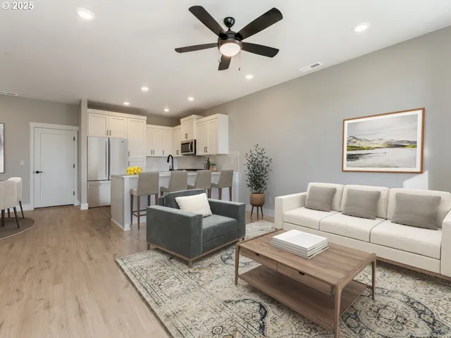 a living room with furniture and kitchen view