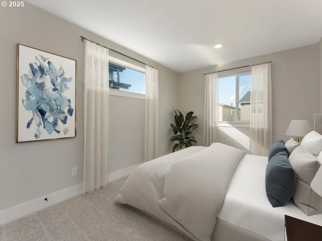 a bedroom with a large bed and a painting on the wall