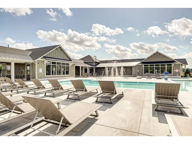 a view of a house with swimming pool and sitting area