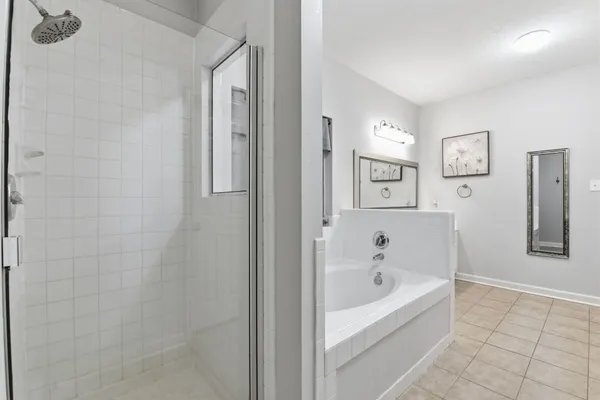 a white bath tub sitting next to a bathroom
