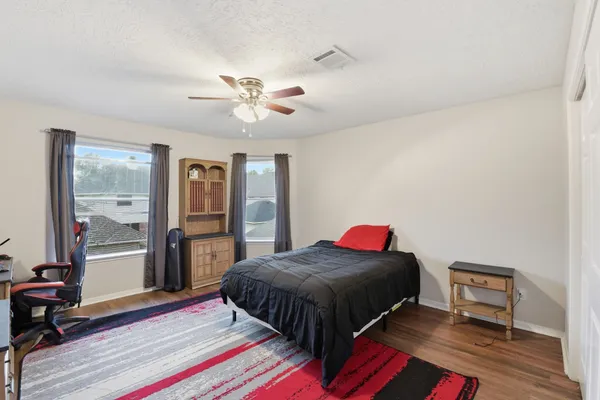 a bedroom with a bed and a chandelier