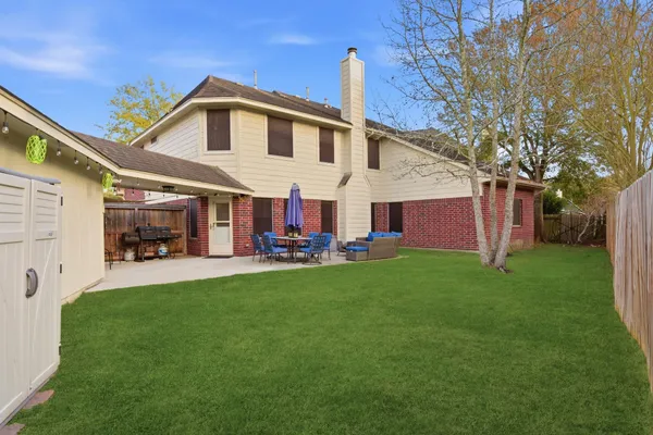 a front view of house with yard and outdoor seating