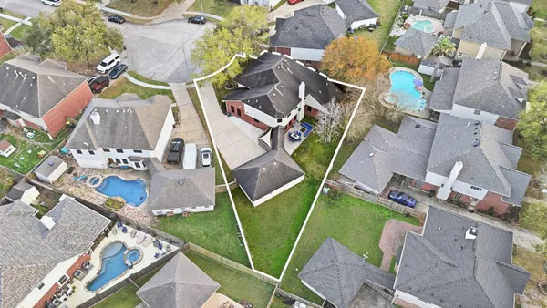 an aerial view of a house with a garden and outdoor space
