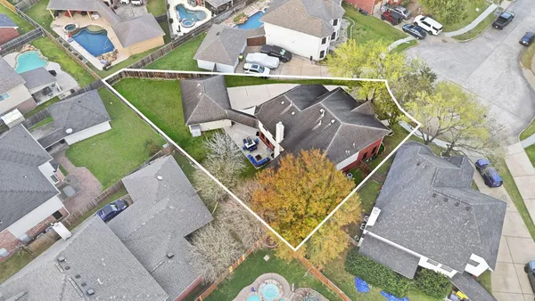 an aerial view of a house with a yard