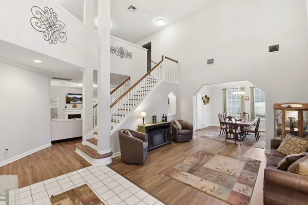 a living room with furniture and wooden floor