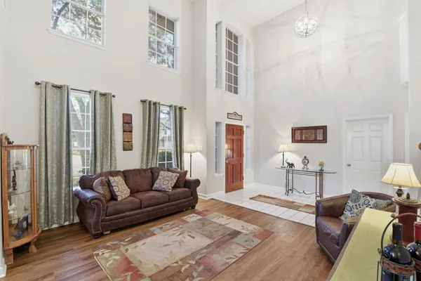 a living room with furniture and wooden floor