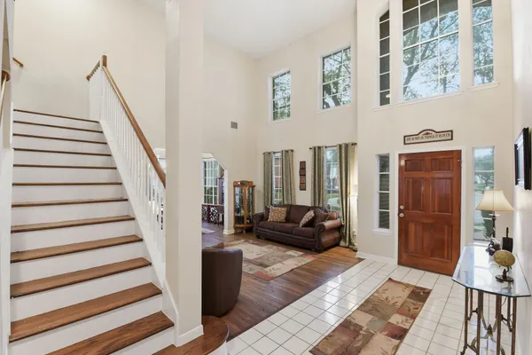 a view of staircase with lots of frames on wall and stairs