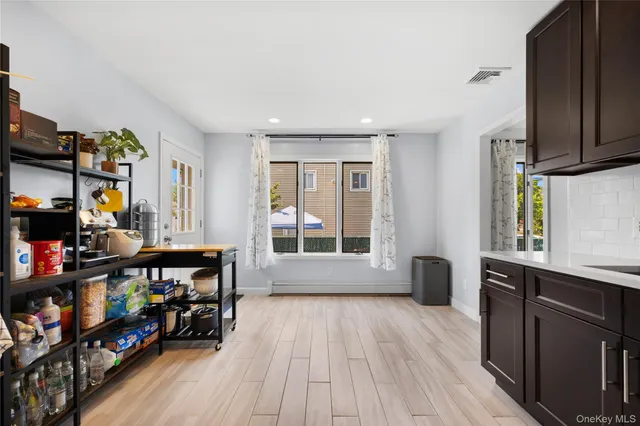 a view of a room with window and wooden floor