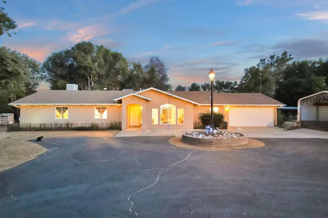 an aerial view of a house with a yard and lake view