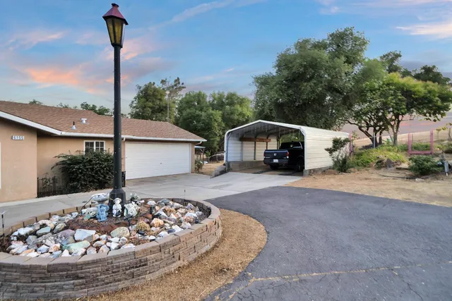 a view of an ocean with a floor to ceiling window and a big yard