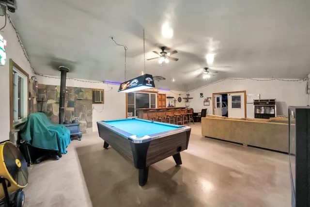 a view of a house with backyard and a tree