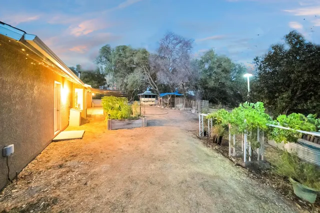 a view of a house with yard and sitting area
