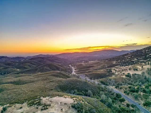 an aerial view of residential house with green space