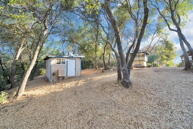 a dining room with furniture a chandelier and wooden floor