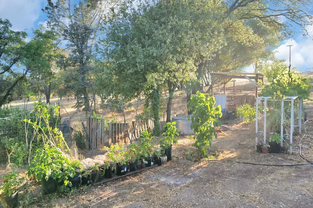 a kitchen with stainless steel appliances granite countertop lots of counter top space and wooden floor