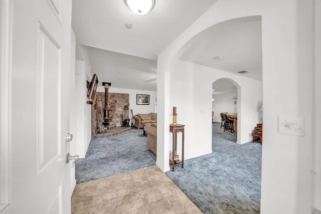 a living room with furniture a table and chairs