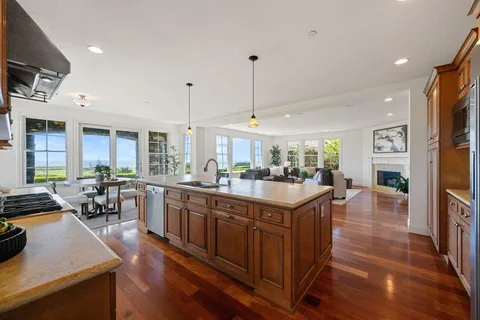 a living room with lots of furniture and kitchen view