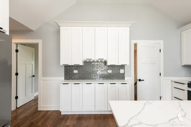a kitchen with a sink a stove a refrigerator and cabinets