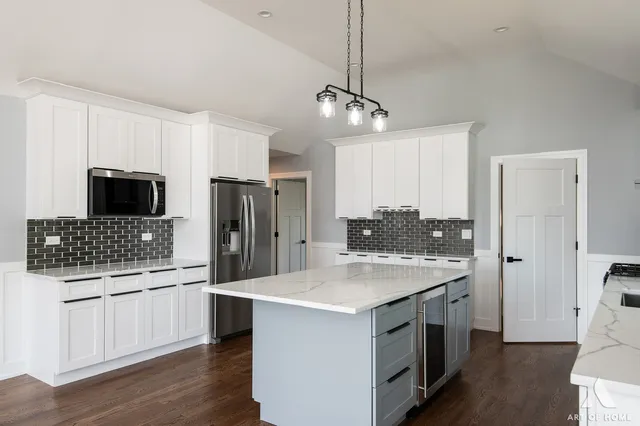 a kitchen with stainless steel appliances kitchen island granite countertop a stove a sink and a granite counter tops