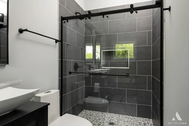 a bathroom with a sink toilet and shower