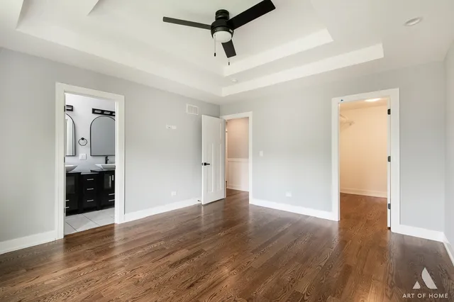 a view of a room with wooden floor and white walls