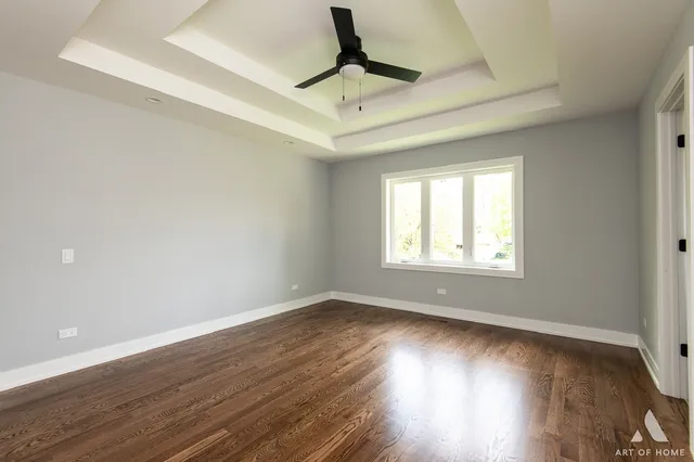 a view of room with wooden floor and ceiling fan