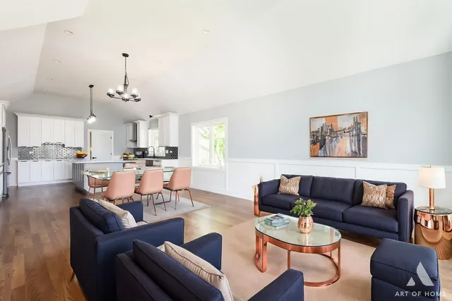 a living room with furniture kitchen view and a chandelier