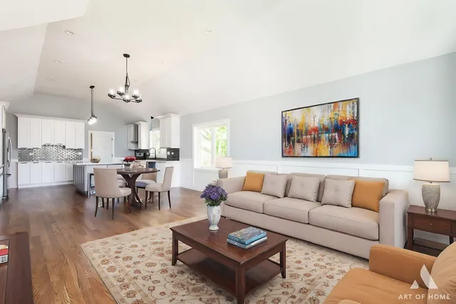 a living room with furniture a rug and a chandelier