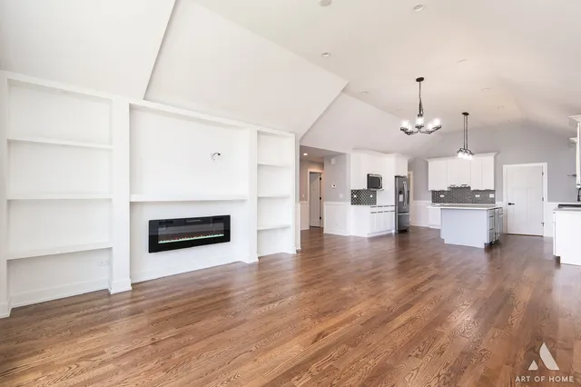 a view of a kitchen with furniture and wooden floor