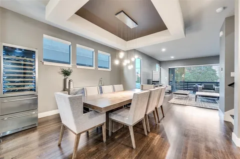 a dining area with furniture window and wooden floor