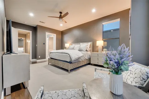 a spacious bedroom with a bed and a potted plant