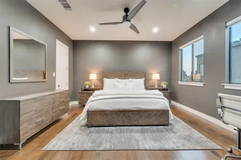 a bedroom with a large bed and a chandelier