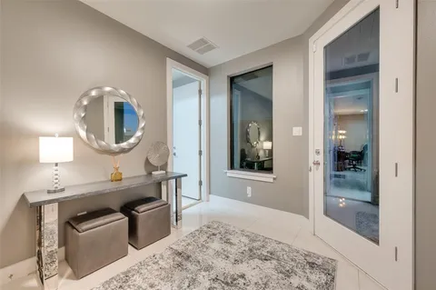 a living room with a mirror and a table