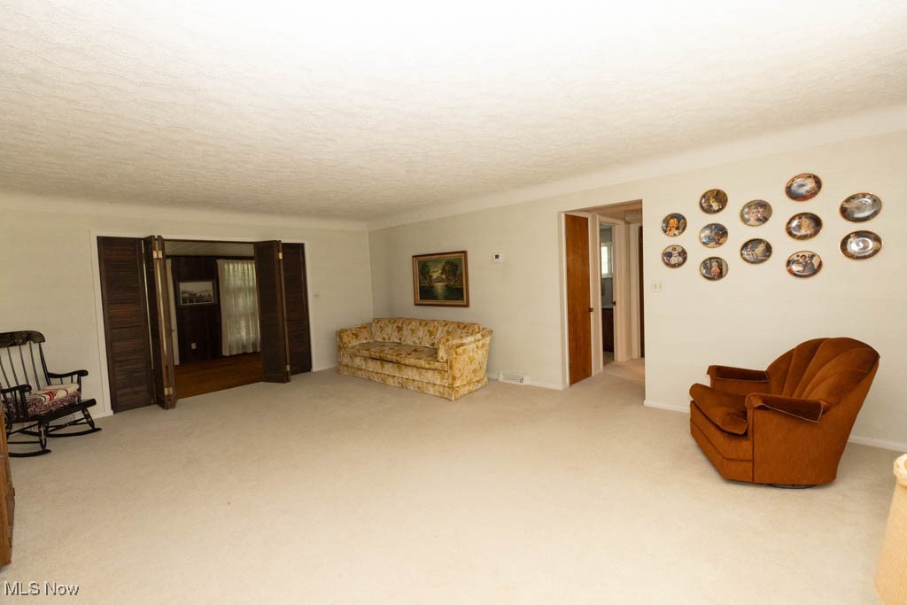 7312 Ivandale Road Independence, OH 44131 - Photo 11 of 44 Sitting room with light colored carpet and a textured ceiling