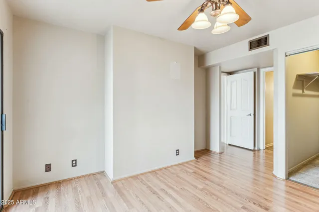 a view of an empty room with wooden floor