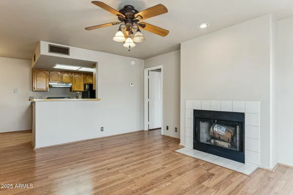 a view of a livingroom with a fireplace and wooden floor