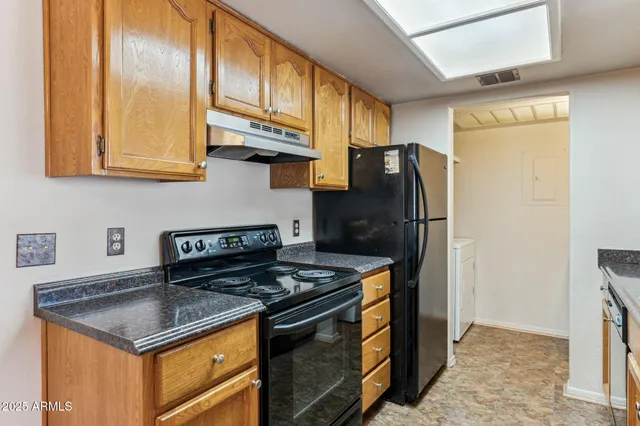 a kitchen with stainless steel appliances granite countertop a stove a refrigerator and a refrigerator