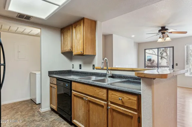 a kitchen with stainless steel appliances granite countertop a sink a stove and a refrigerator