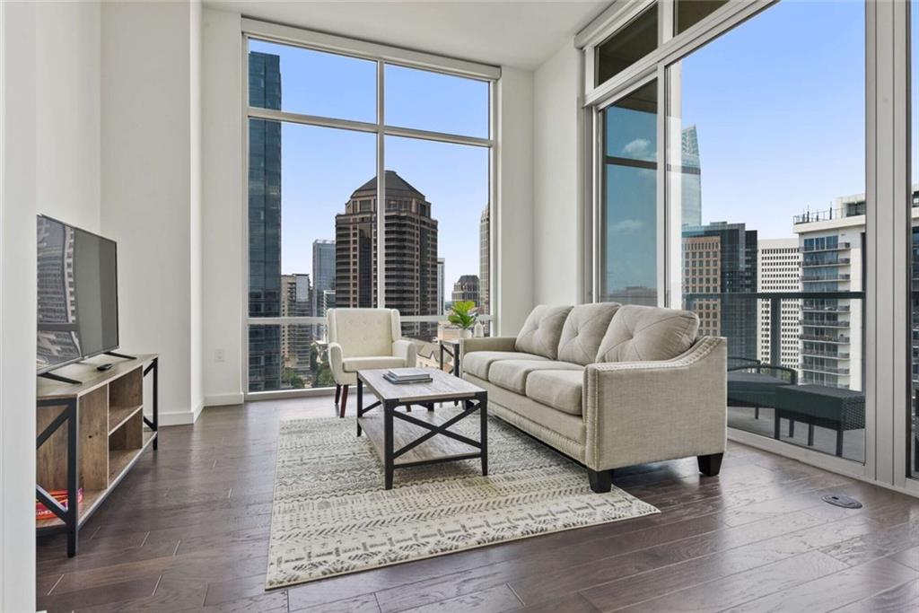 205 12th Street Northeast, Unit 3 Atlanta, GA 30309 - Photo 1 of 24 a living room with furniture a rug and a window