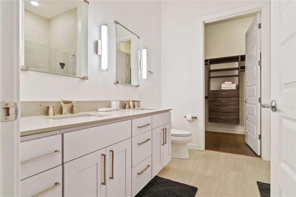 205 12th Street Northeast, Unit 3 Atlanta, GA 30309 - Photo 17 of 24 a spacious bathroom with a granite countertop sink toilet and shower
