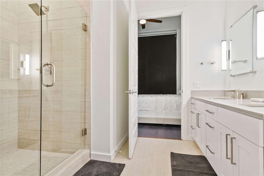 205 12th Street Northeast, Unit 3 Atlanta, GA 30309 - Photo 18 of 24 a bathroom with a double vanity sink and mirror