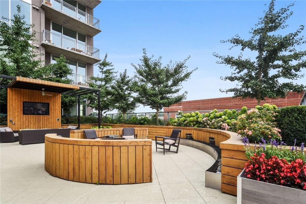 205 12th Street Northeast, Unit 3 Atlanta, GA 30309 - Photo 3 of 24 a view of a swimming pool with a patio