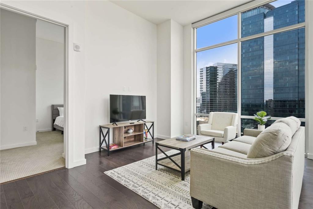 205 12th Street Northeast, Unit 3 Atlanta, GA 30309 - Photo 9 of 24 a living room with furniture and a flat screen tv