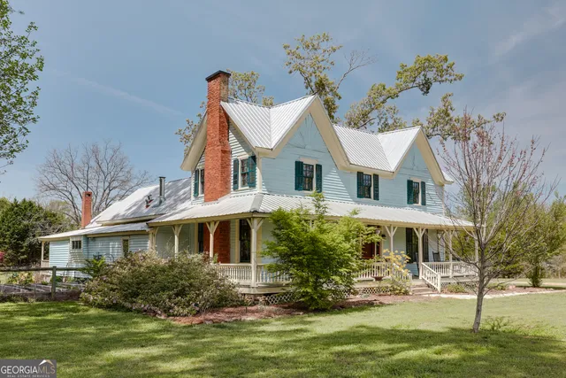 a living room with furniture a flat screen tv and kitchen view
