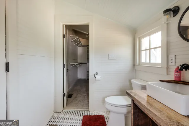 a view of a lake with lawn chairs and a table